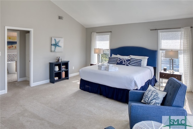 carpeted bedroom featuring high vaulted ceiling