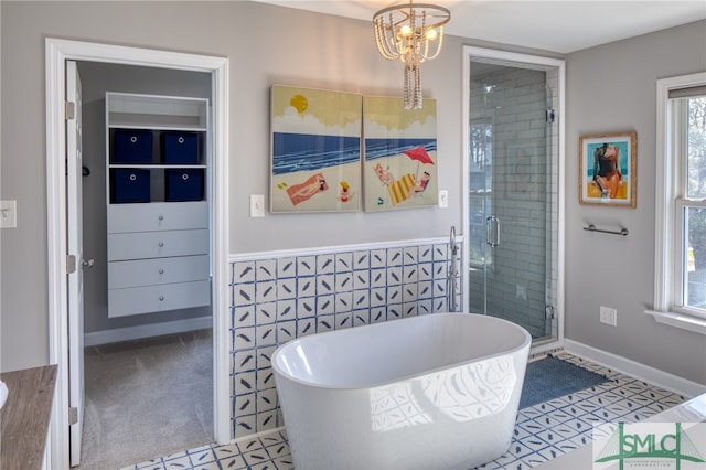 bathroom featuring shower with separate bathtub, tile flooring, a chandelier, and a wealth of natural light