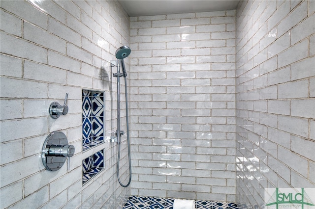 interior details featuring a tile shower