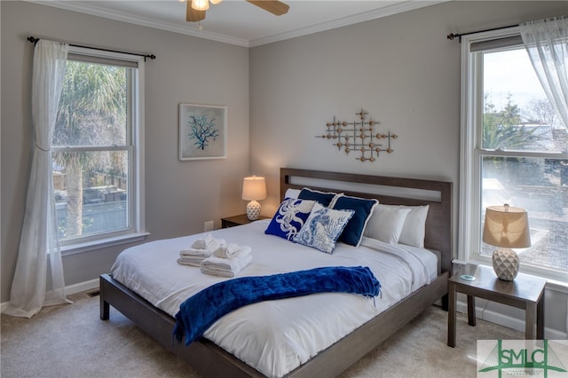 carpeted bedroom with ceiling fan and crown molding