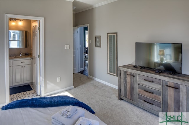 carpeted bedroom featuring ensuite bath and crown molding