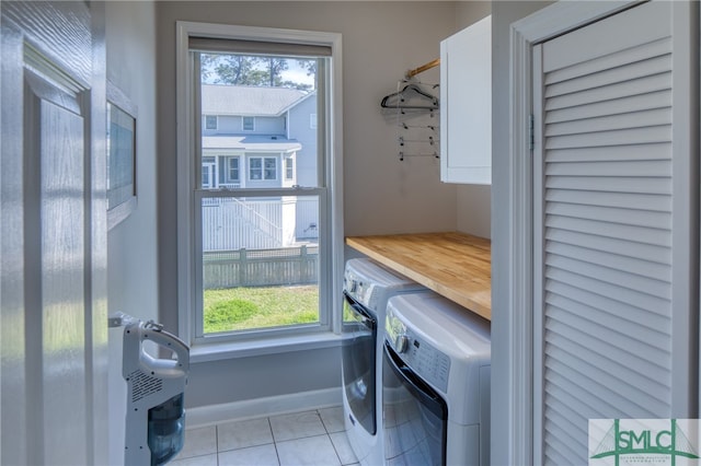 washroom featuring separate washer and dryer and light tile floors