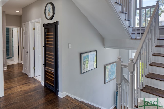 stairs featuring dark wood-type flooring and a towering ceiling