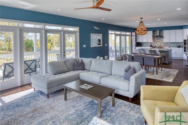 living room with dark hardwood / wood-style floors and ceiling fan