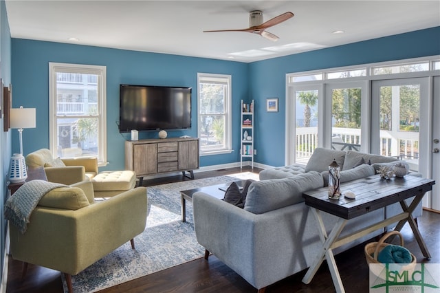 living room featuring plenty of natural light, ceiling fan, and dark hardwood / wood-style flooring