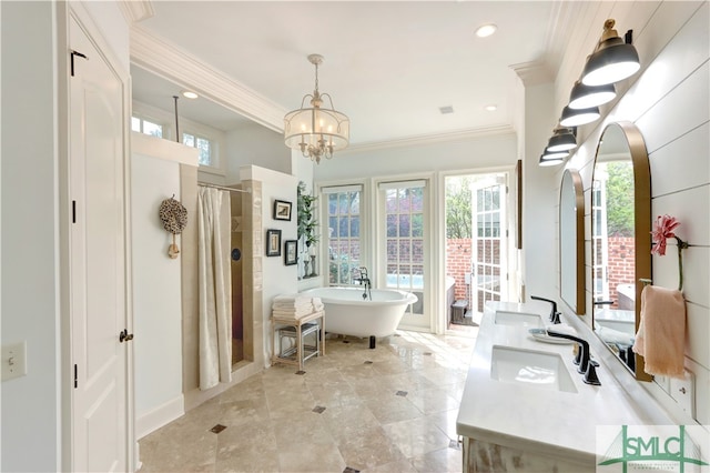 interior space with a bath, dual sinks, crown molding, tile floors, and an inviting chandelier