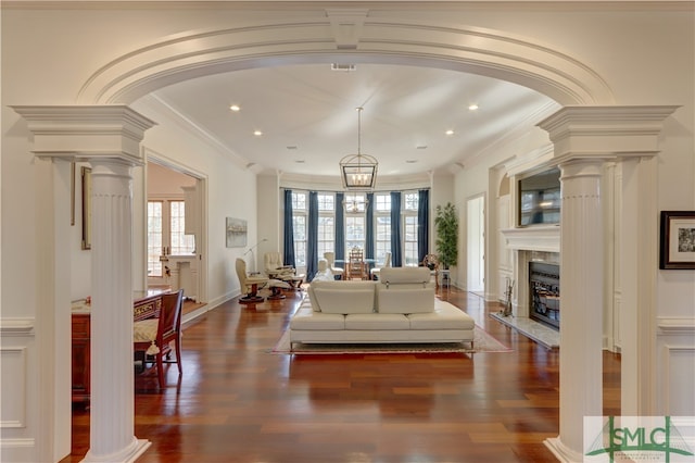 living room featuring a wealth of natural light and decorative columns