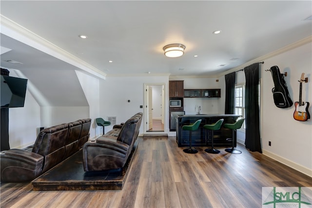 living room with hardwood / wood-style flooring and crown molding