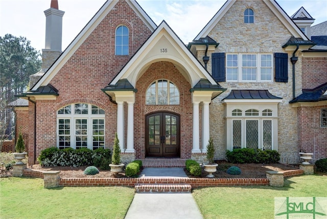 view of front of home featuring french doors and a front lawn