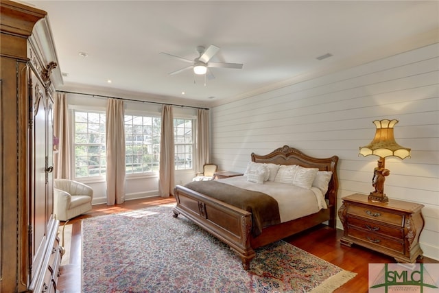 bedroom with dark hardwood / wood-style floors and ceiling fan