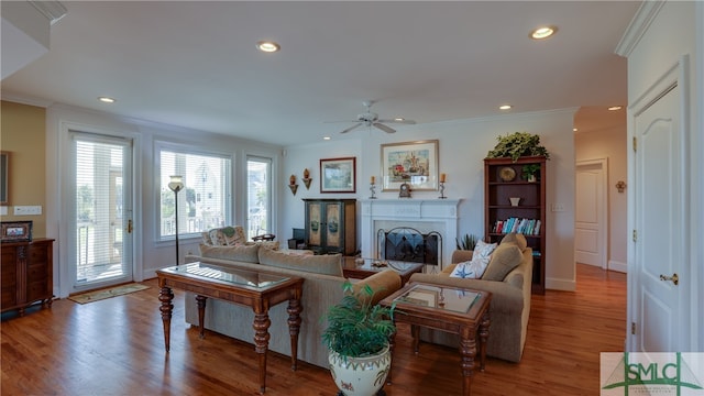living room featuring ceiling fan, crown molding, and dark hardwood / wood-style floors