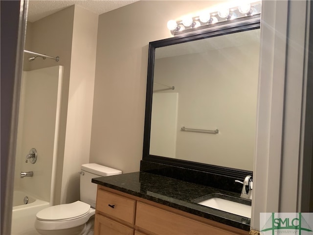 full bathroom with large vanity, shower / washtub combination, toilet, and a textured ceiling