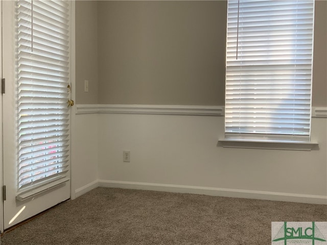 unfurnished room with dark carpet