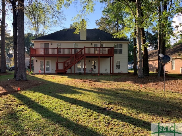 back of house with a wooden deck and a yard