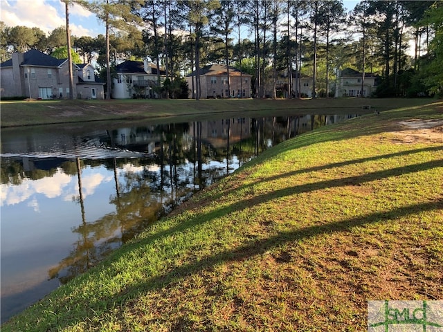 exterior space with a lawn and a water view