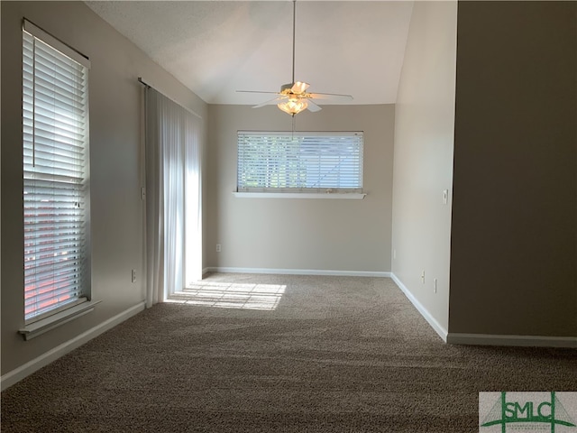 carpeted spare room with ceiling fan and lofted ceiling