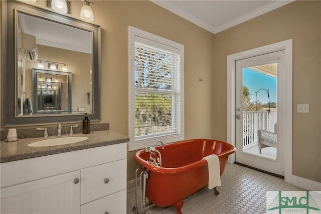 bathroom featuring plenty of natural light, vanity, tile floors, and a bathtub