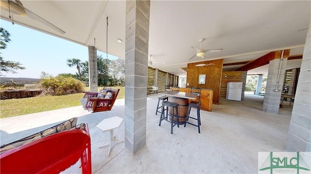 view of patio / terrace featuring ceiling fan and exterior bar