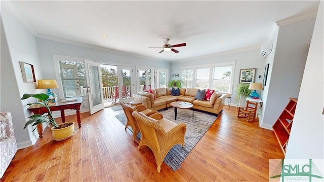 living room featuring ornamental molding, plenty of natural light, ceiling fan, and light wood-type flooring