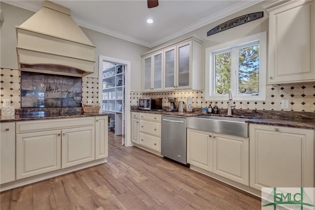 kitchen with tasteful backsplash, dark stone counters, and dishwasher