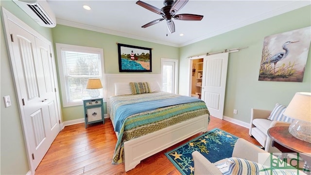 bedroom with hardwood / wood-style floors, ceiling fan, a wall unit AC, and ornamental molding