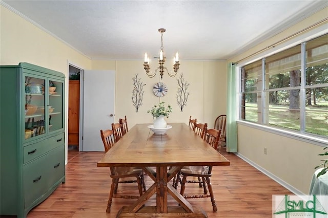 dining space featuring light hardwood / wood-style floors and a notable chandelier