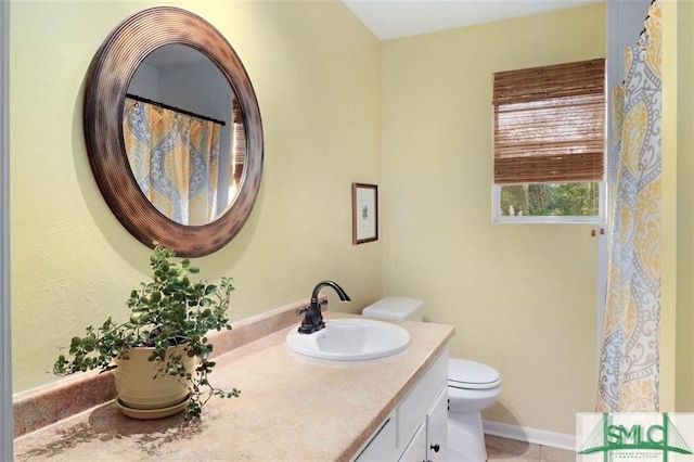 bathroom featuring tile patterned floors, vanity, and toilet