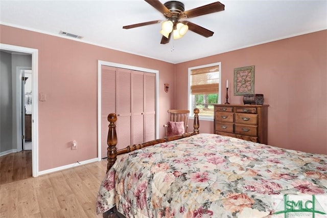 bedroom with ceiling fan, a closet, and light hardwood / wood-style flooring