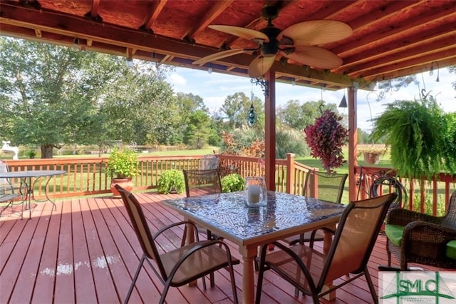 deck with a yard and ceiling fan