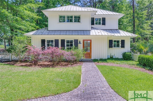 modern farmhouse style home with a front lawn