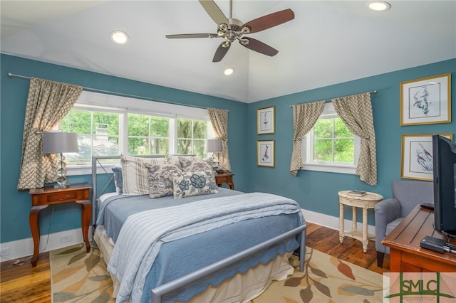 bedroom with hardwood / wood-style floors, ceiling fan, and lofted ceiling