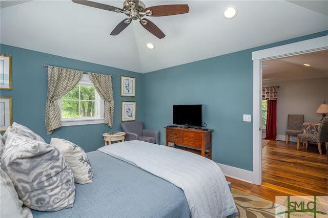 bedroom featuring ceiling fan, hardwood / wood-style floors, and vaulted ceiling