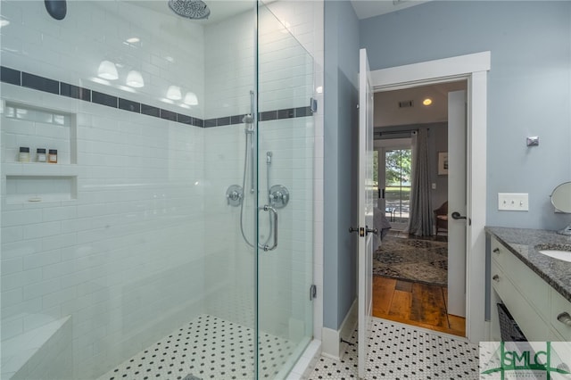 bathroom featuring vanity, wood-type flooring, and walk in shower