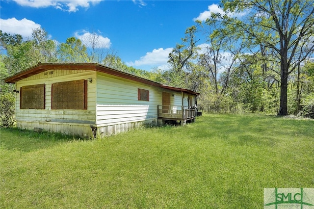 view of side of home featuring a lawn