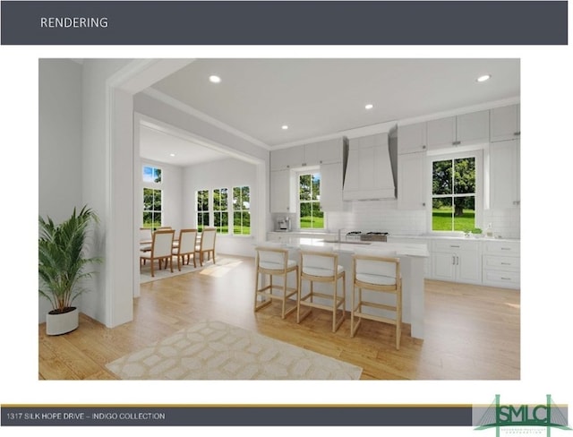 kitchen featuring light wood-type flooring, custom range hood, white cabinets, backsplash, and a kitchen bar