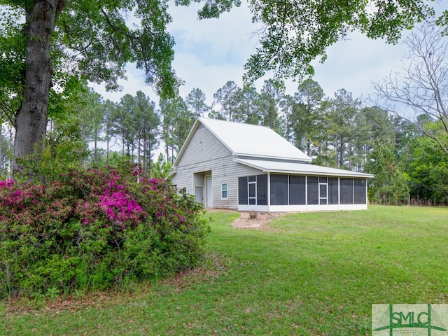 exterior space with a lawn and a sunroom