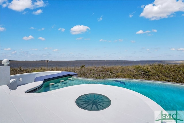 view of swimming pool with a hot tub