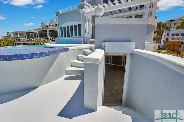 view of patio featuring a balcony and a pergola