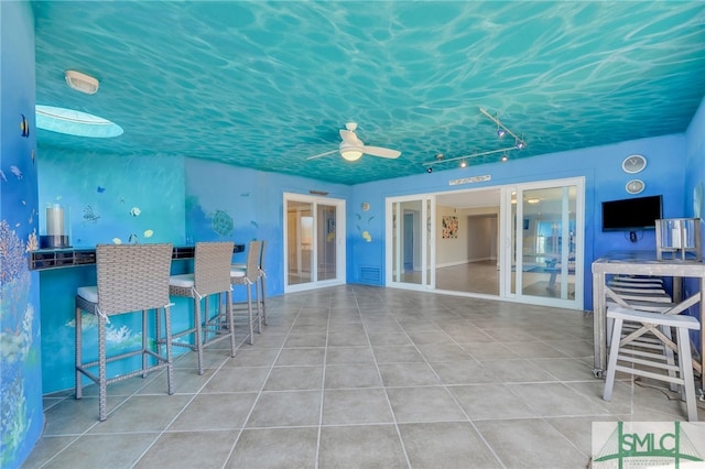 view of patio / terrace with a bar and ceiling fan