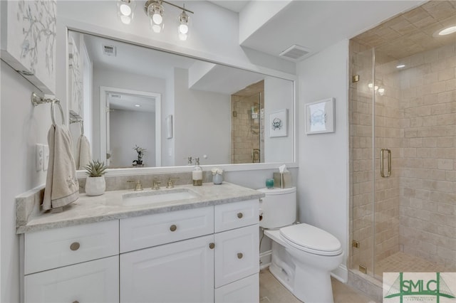 bathroom featuring tile floors, toilet, vanity, and an enclosed shower