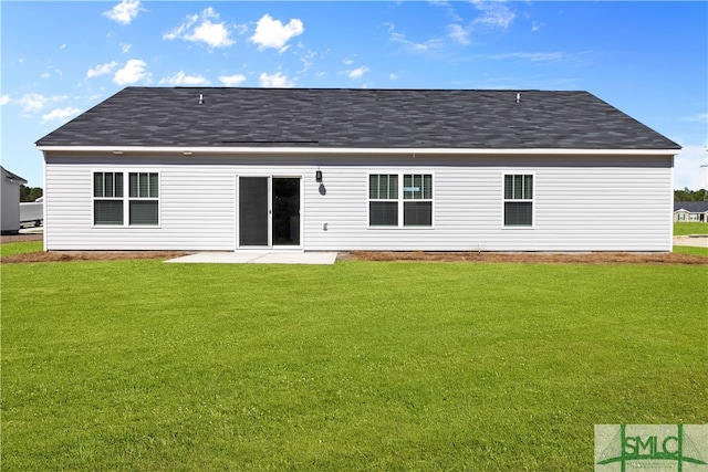 rear view of property with a patio and a yard