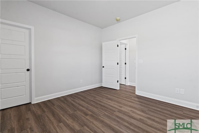 empty room featuring dark wood-type flooring