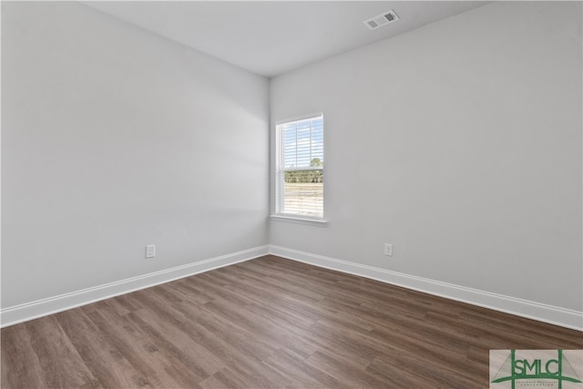 empty room with hardwood / wood-style flooring