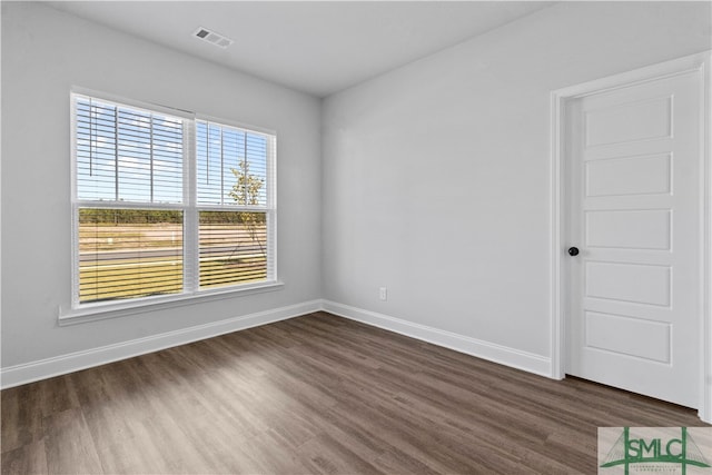 empty room with dark wood-type flooring