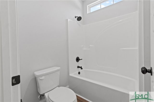 bathroom with toilet and washtub / shower combination