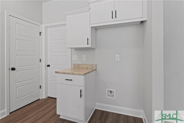 kitchen with dark wood-type flooring, light stone countertops, and white cabinets