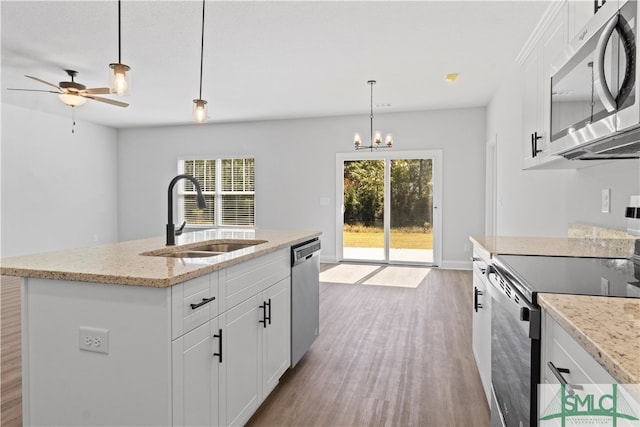 kitchen featuring white cabinets, stainless steel appliances, and plenty of natural light