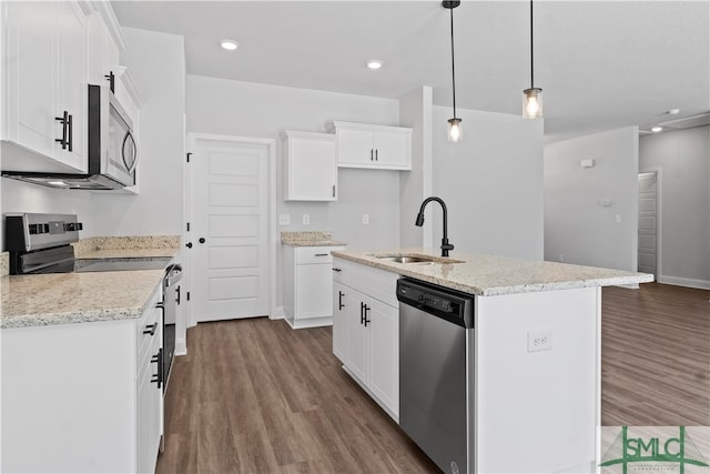 kitchen featuring sink, appliances with stainless steel finishes, a kitchen island with sink, and white cabinetry