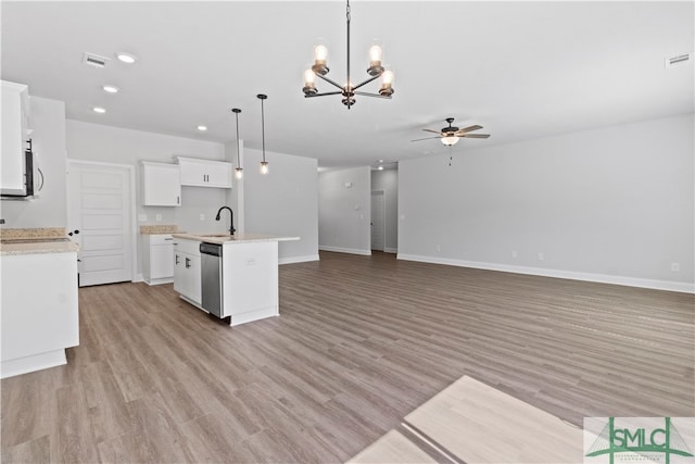 kitchen with white cabinetry, light hardwood / wood-style flooring, a center island with sink, and hanging light fixtures