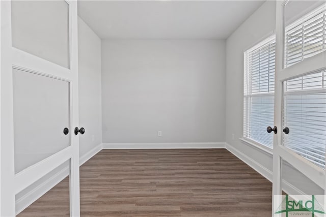 unfurnished room featuring dark wood-type flooring and french doors